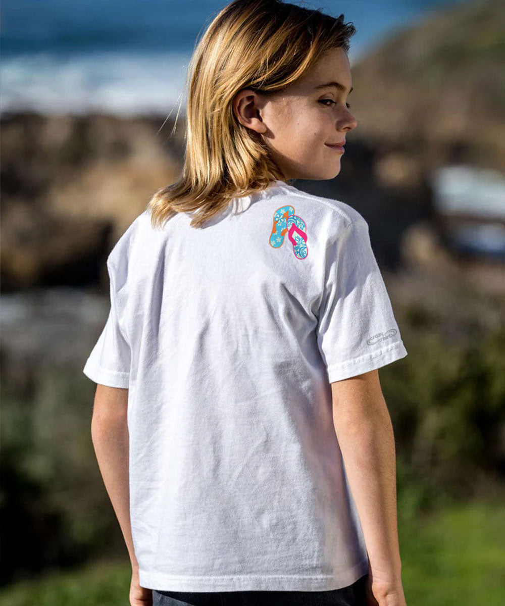 Person wearing a white t-shirt with a colorful design on the back, standing outdoors. View 3