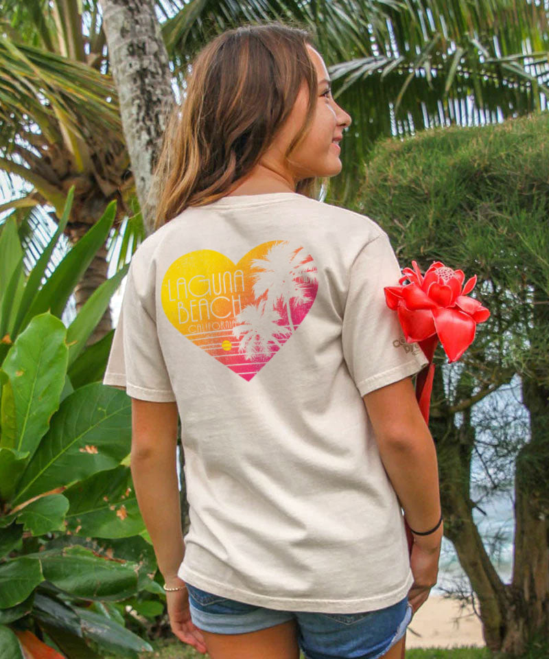 A young woman wearing a t-shirt with a colorful heart design outdoors View 2