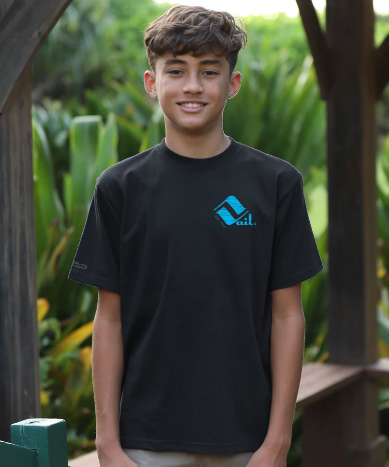 Young person wearing a black t-shirt with a blue logo in an outdoor setting View 3