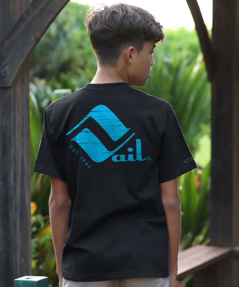 A young boy wearing a black t-shirt with a blue logo outdoors View 2