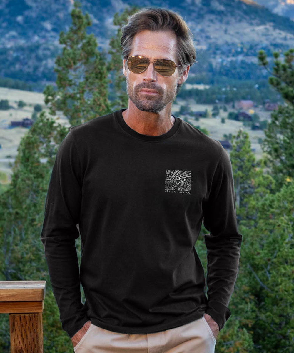 Man wearing a black long-sleeve shirt with a logo in a mountainous landscape View 3