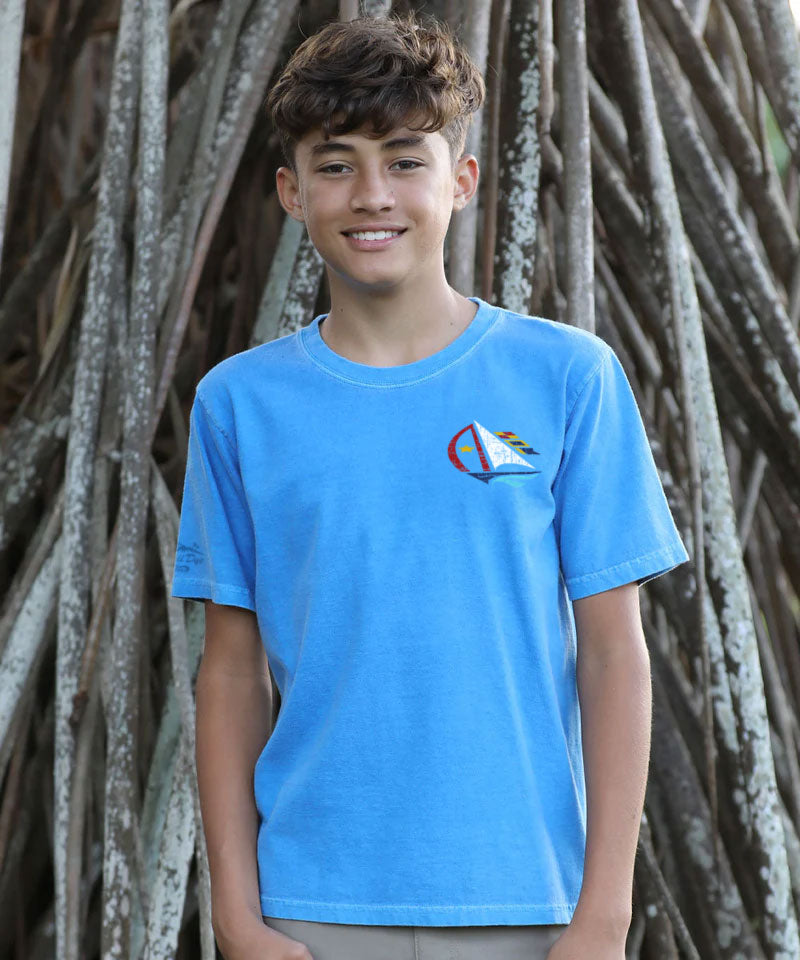 Person wearing a blue t-shirt with a logo against a natural background View 3