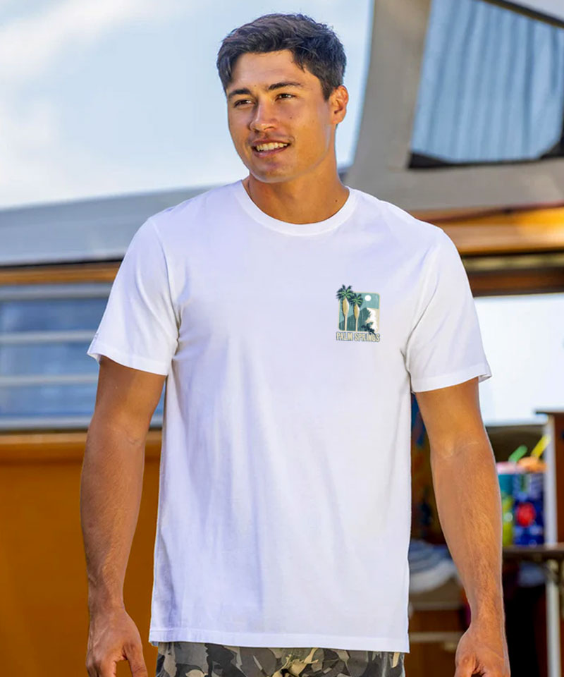 Man wearing a white t-shirt with a small graphic standing outside View 3