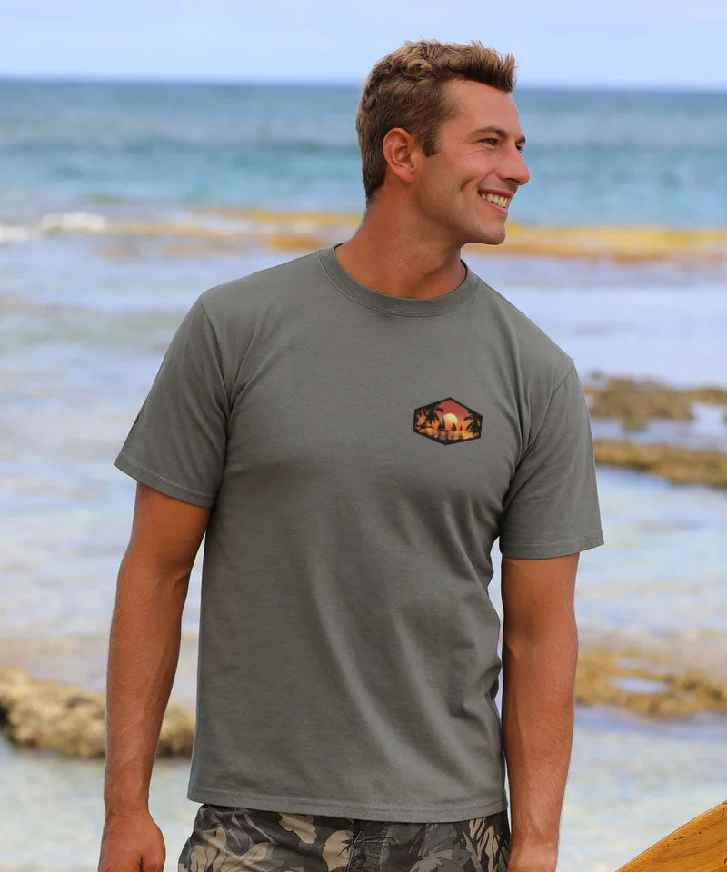 Man wearing a gray t-shirt with a logo on a beach View 3