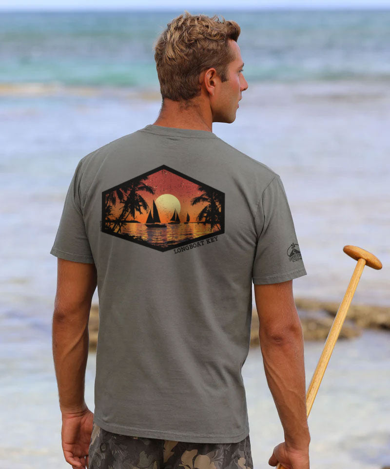 Man wearing a gray t-shirt with a sunset design on the beach View 2