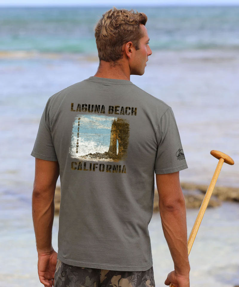 Man wearing a gray t-shirt with 'Laguna Beach, California' printed on the back, standing on a beach. View 2