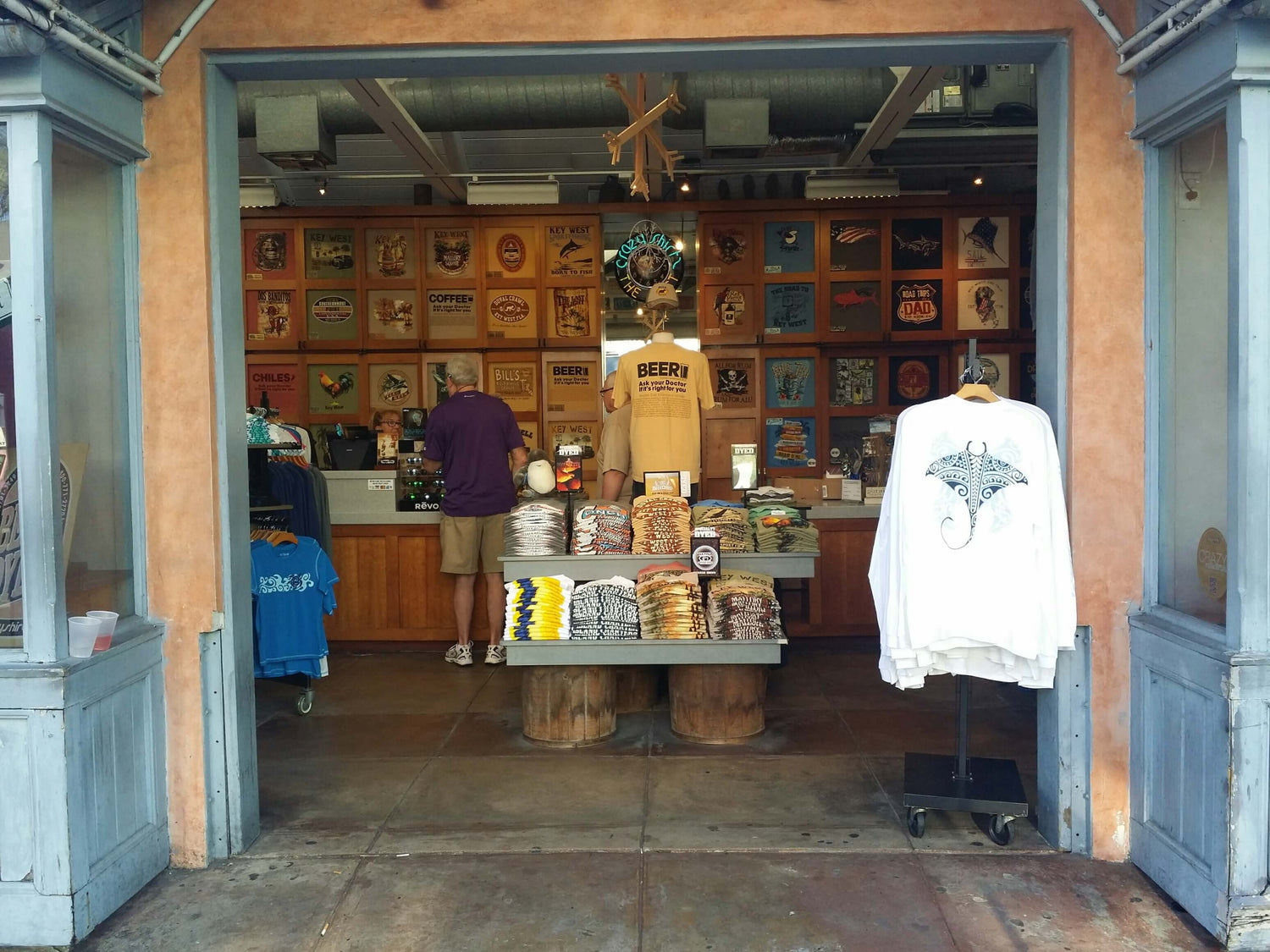 Storefront with merchandise and a person inside, featuring a variety of items on display.