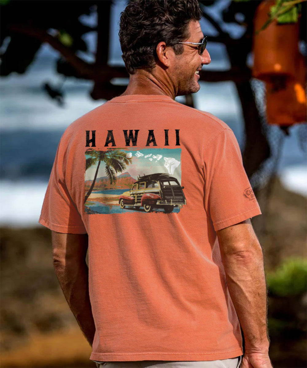 Man wearing a t-shirt with 'Hawaii' and a vintage car graphic on the back. View 2