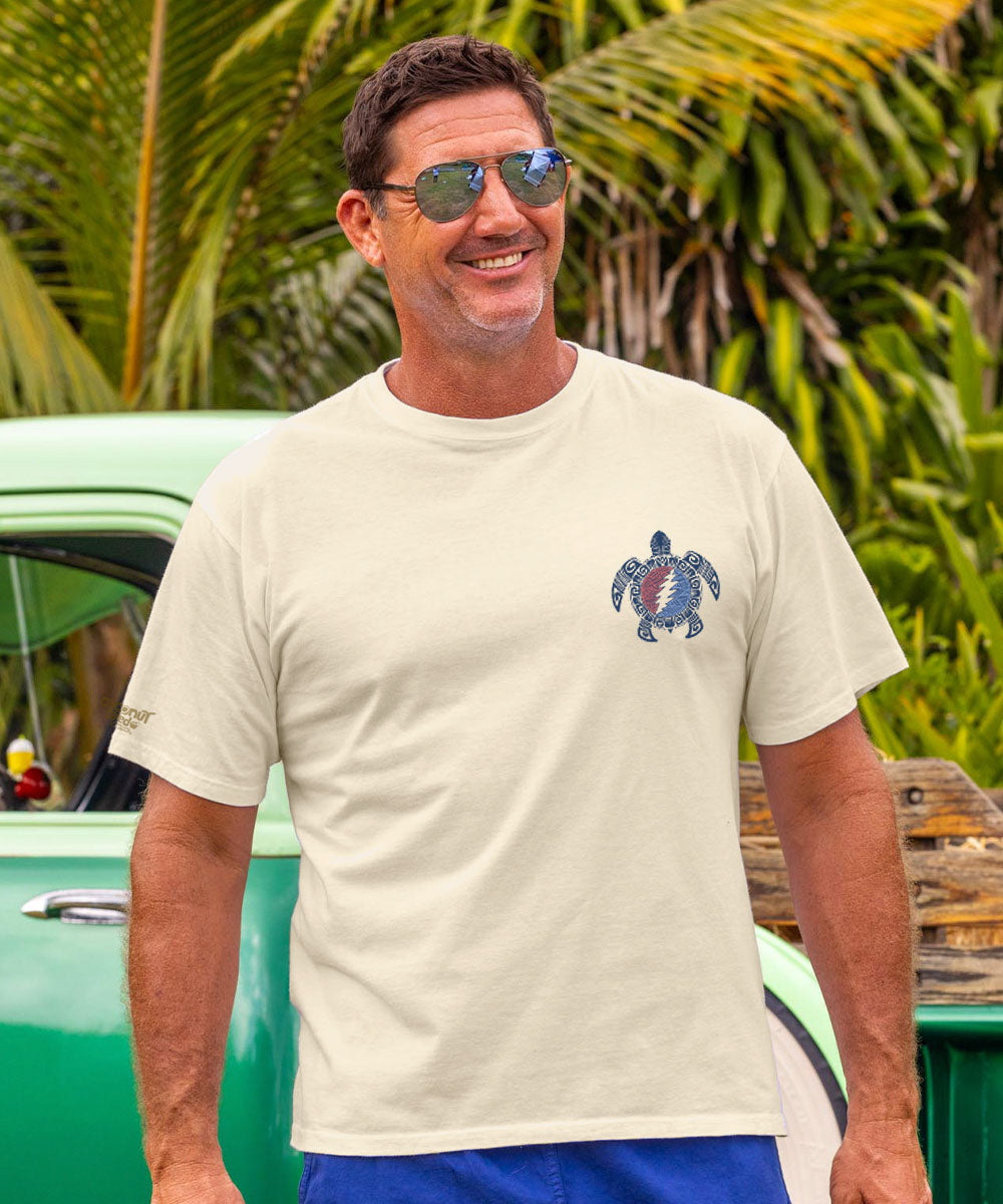 Man wearing a white t-shirt with a turtle design and sunglasses, outdoors. View 3