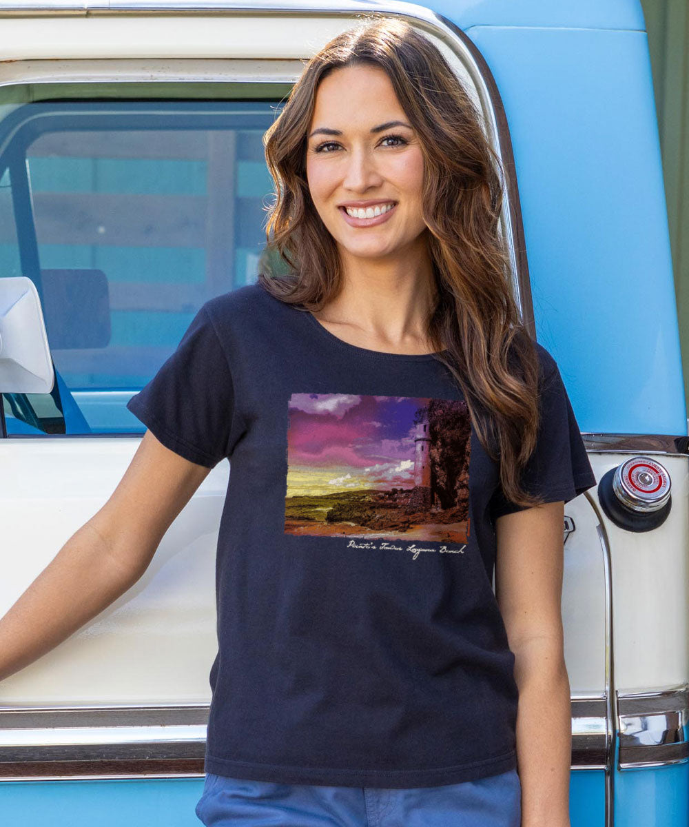 Woman wearing a t-shirt with a scenic design in front of a vintage vehicle View 2