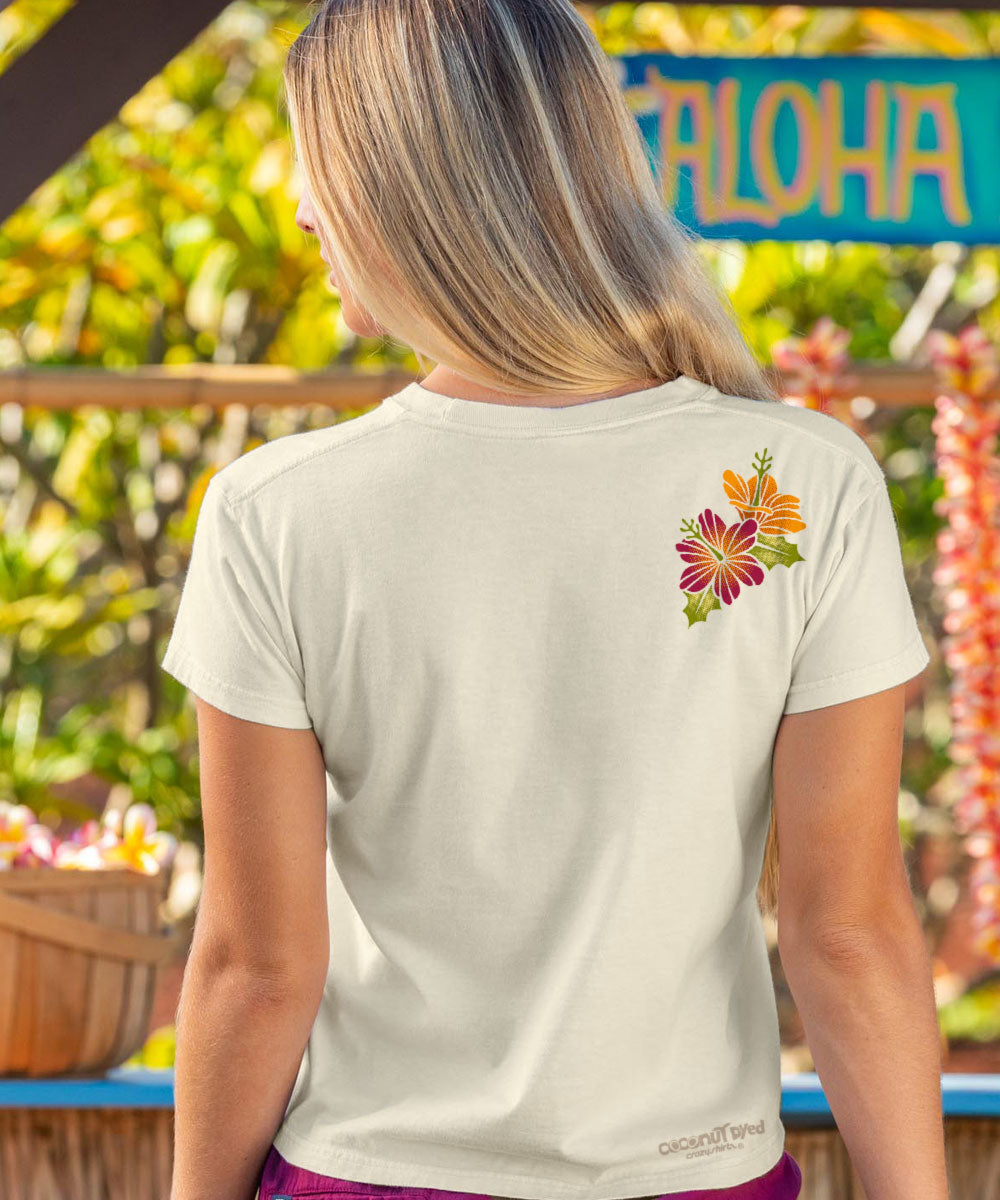Woman wearing a white t-shirt with a colorful flower design in a tropical setting View 3