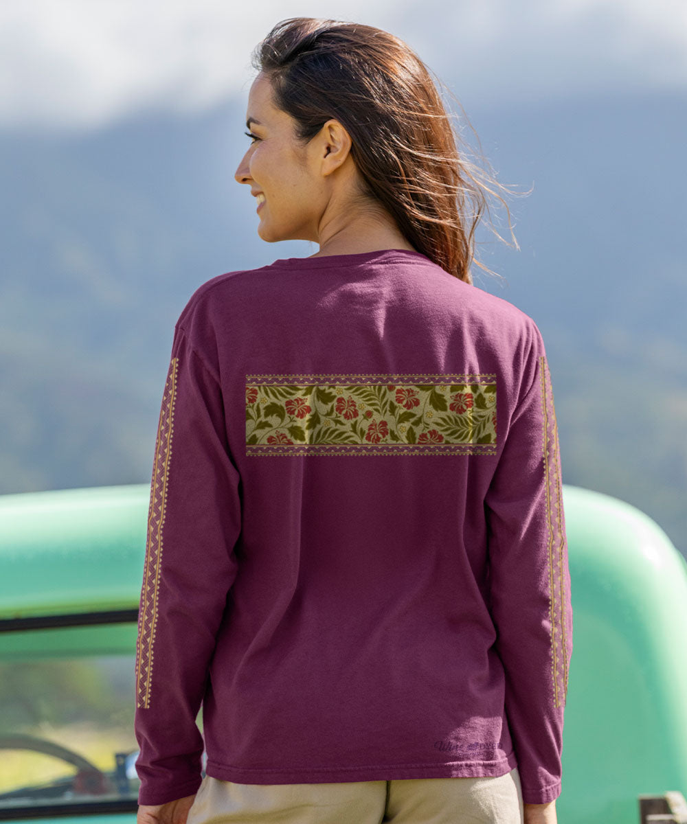 Woman wearing a purple long-sleeve shirt with floral pattern on the back, standing outdoors. View 3