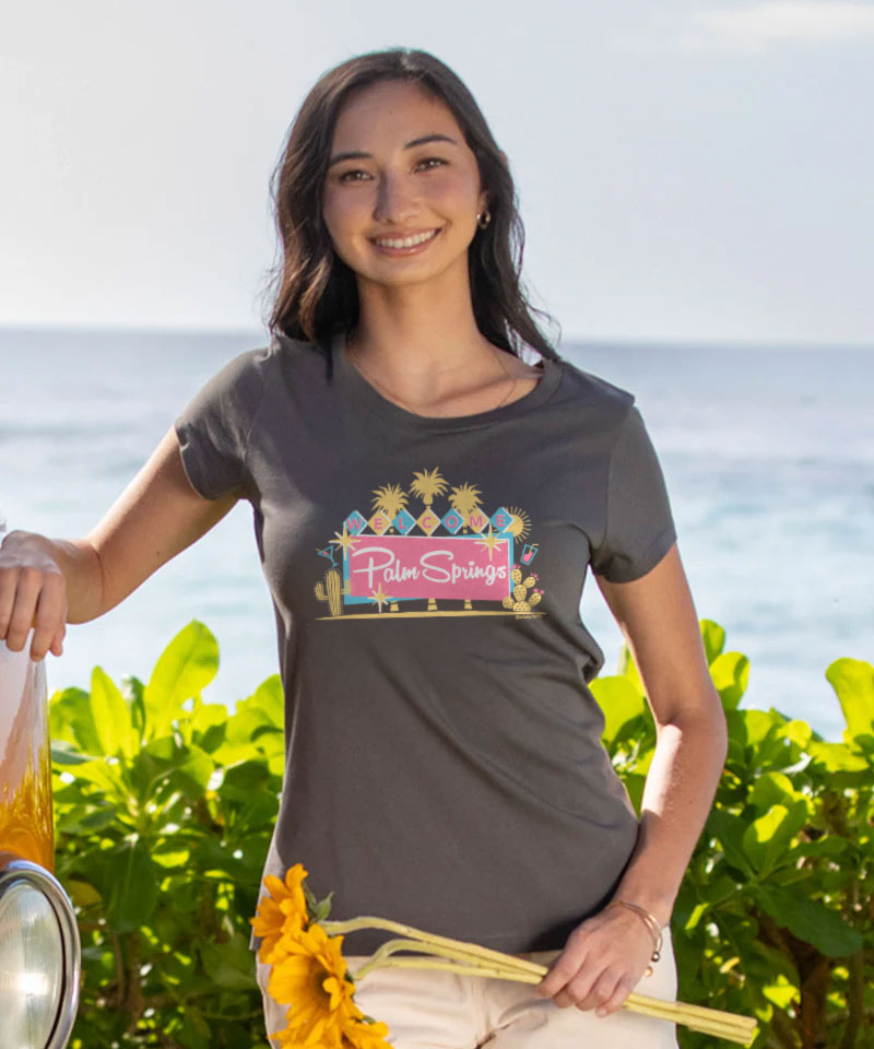 Woman wearing a t-shirt with a 'Palm Springs' design by the ocean View 2