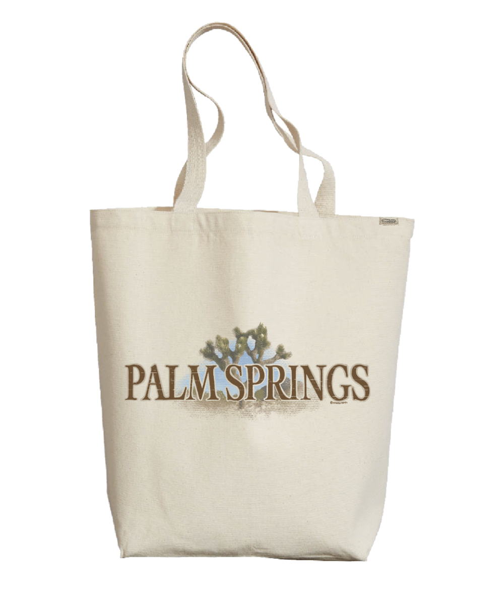 Beige tote bag with 'Palm Springs' text and palm tree design on a white background View 1