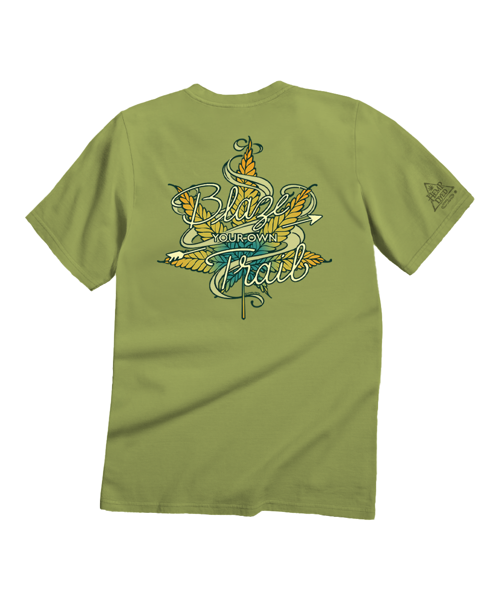 An olive green short-sleeve t-shirt shown from the back, featuring a large graphic print with the words 'Blind Date with Trail' in stylized lettering over yellow and teal leaves. View 1
