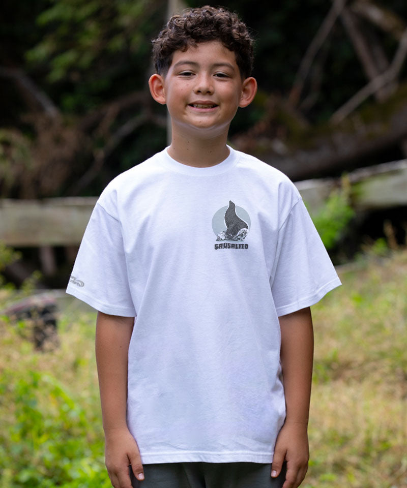 Child wearing a white t-shirt with a logo outdoors View 3