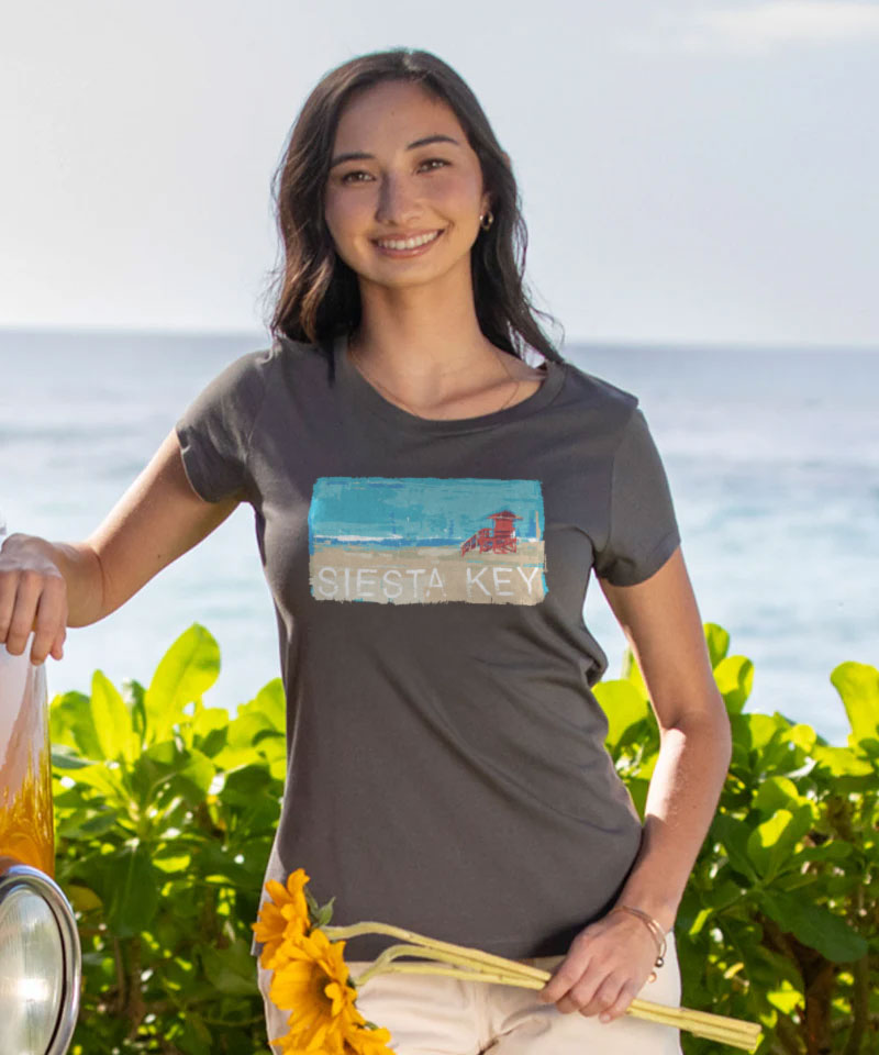 Woman wearing a t-shirt with a Siesta Key graphic on a beach View 2