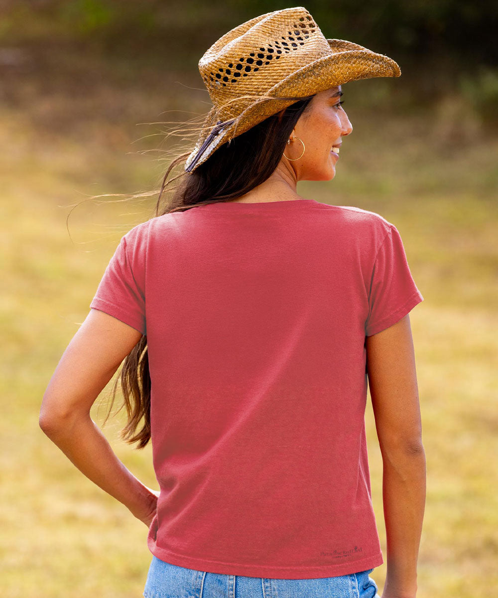 Woman wearing a red t-shirt and straw hat in a field View 3