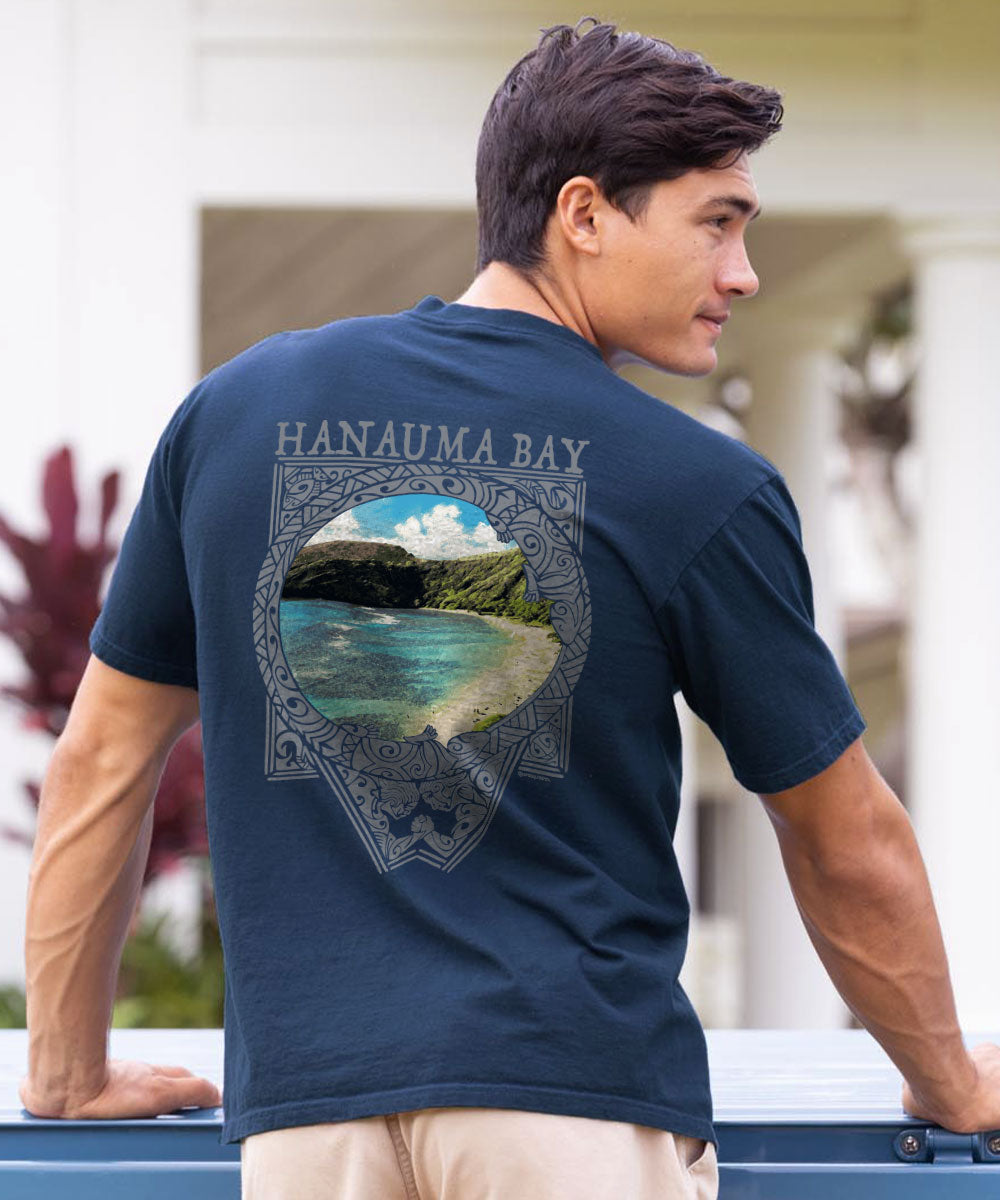 Man wearing a navy blue t-shirt with 'Hanauma Bay' design on the back, standing outdoors. View 2