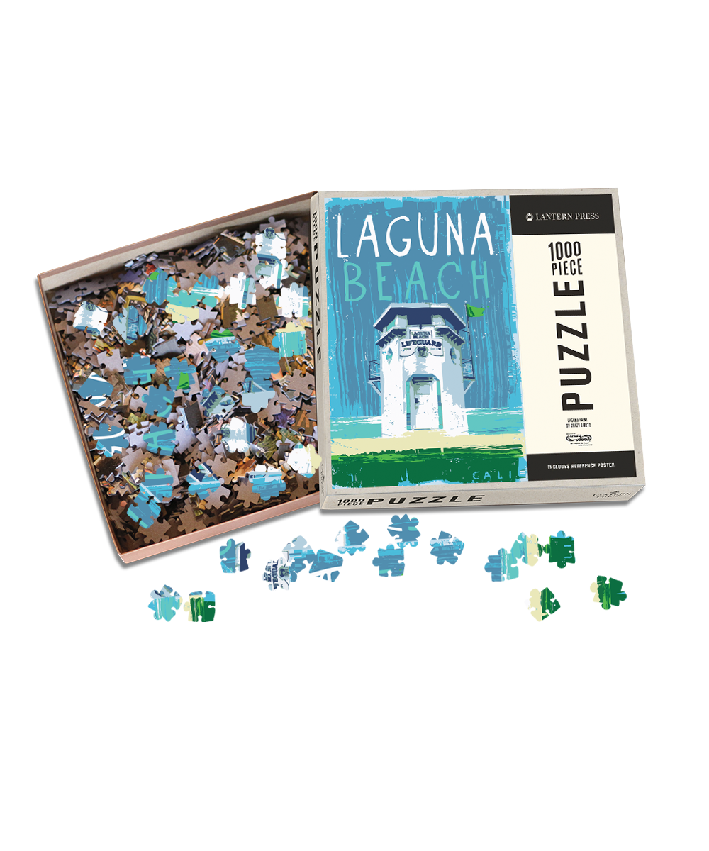 Jigsaw puzzle with pieces scattered on a white background, featuring a box labeled 'Laguna Beach'. View 1