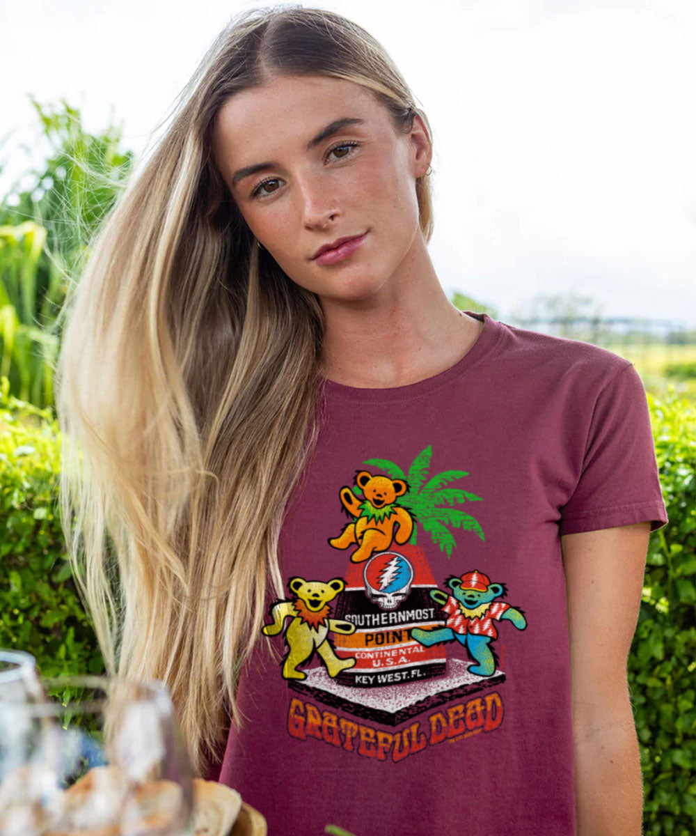 Woman wearing a Grateful Dead t-shirt with colorful bear graphics outdoors. View 2