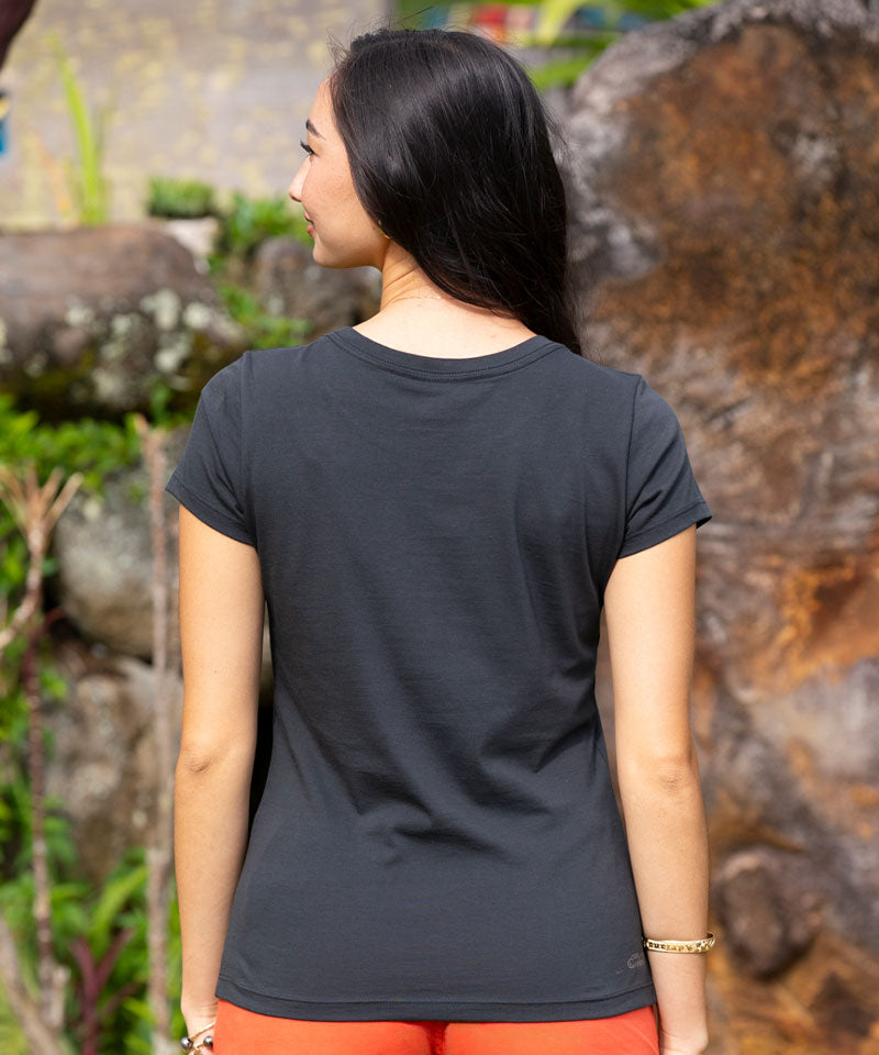 Women wearing a black t-shirt standing in front of a rock wall  View 3