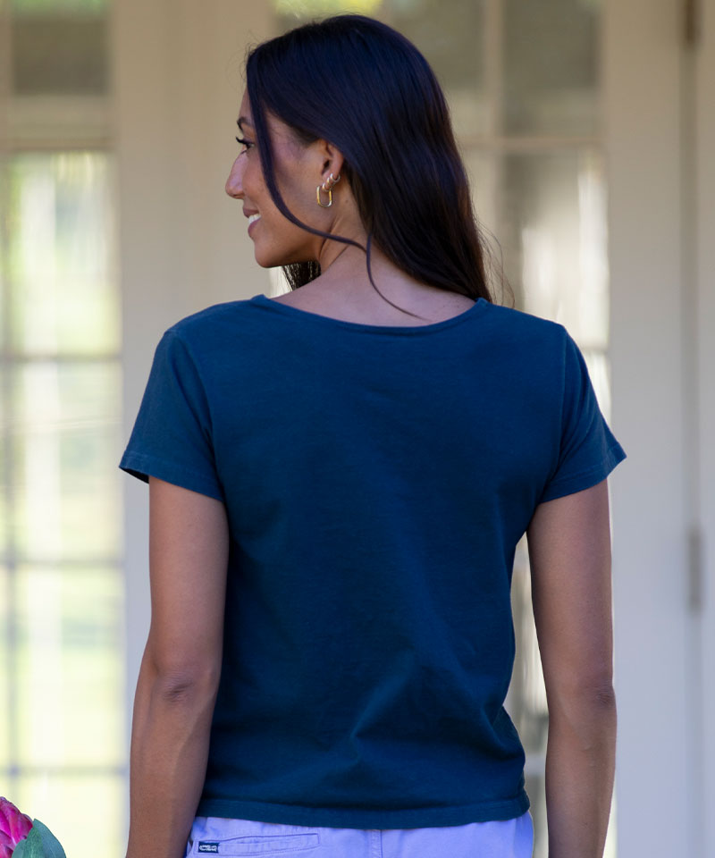 Woman wearing a blue t-shirt with a blurred background View 3