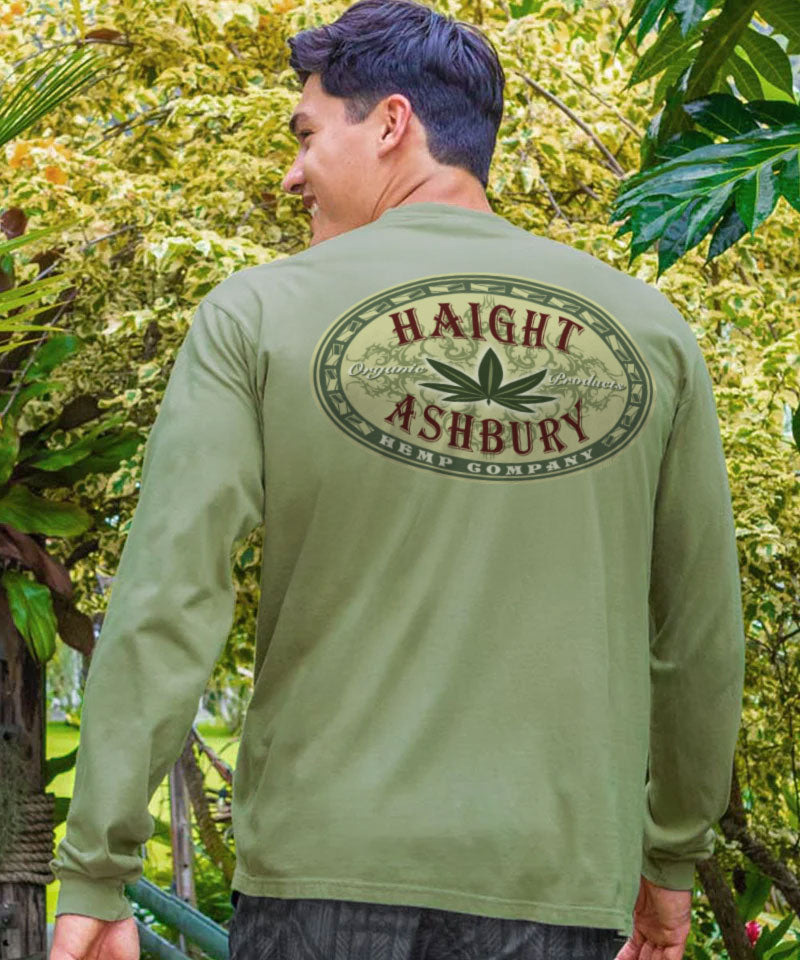 Man wearing a green long-sleeve shirt with 'Haight Ashbury Hemp Company' logo standing outdoors. View 2