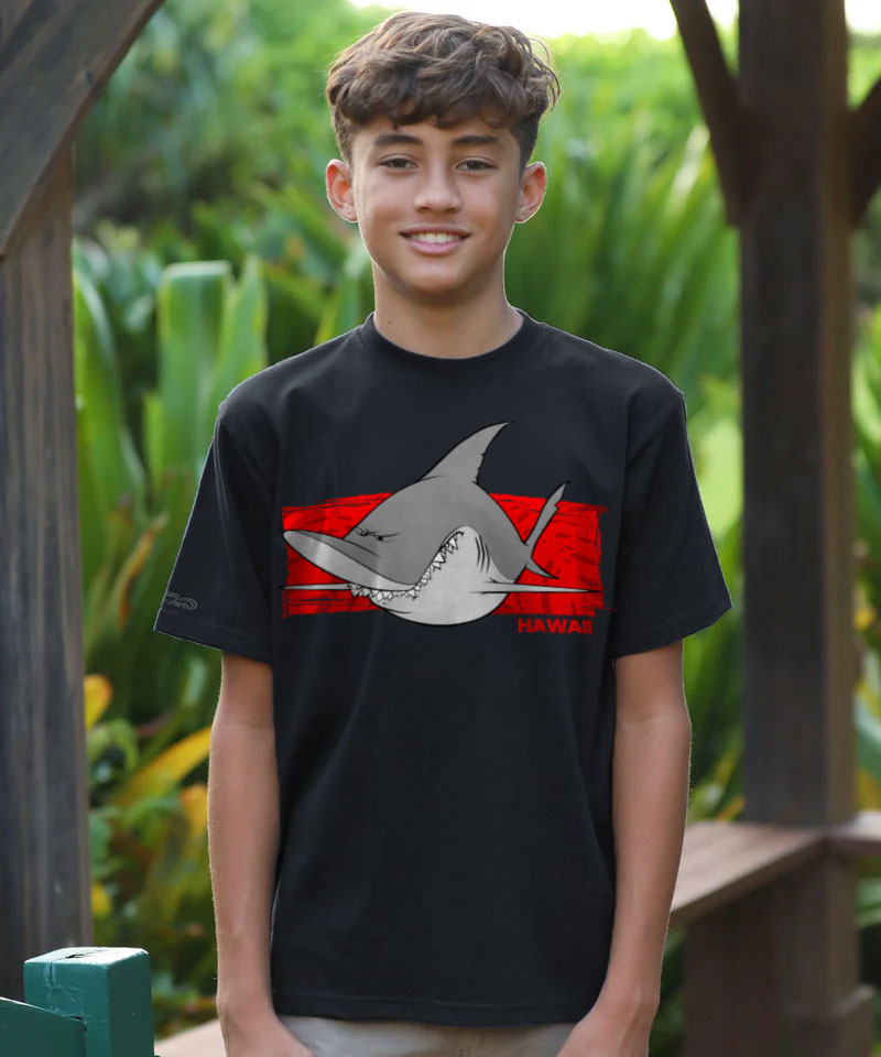 Person wearing a black t-shirt with a shark graphic design outdoors. View 2