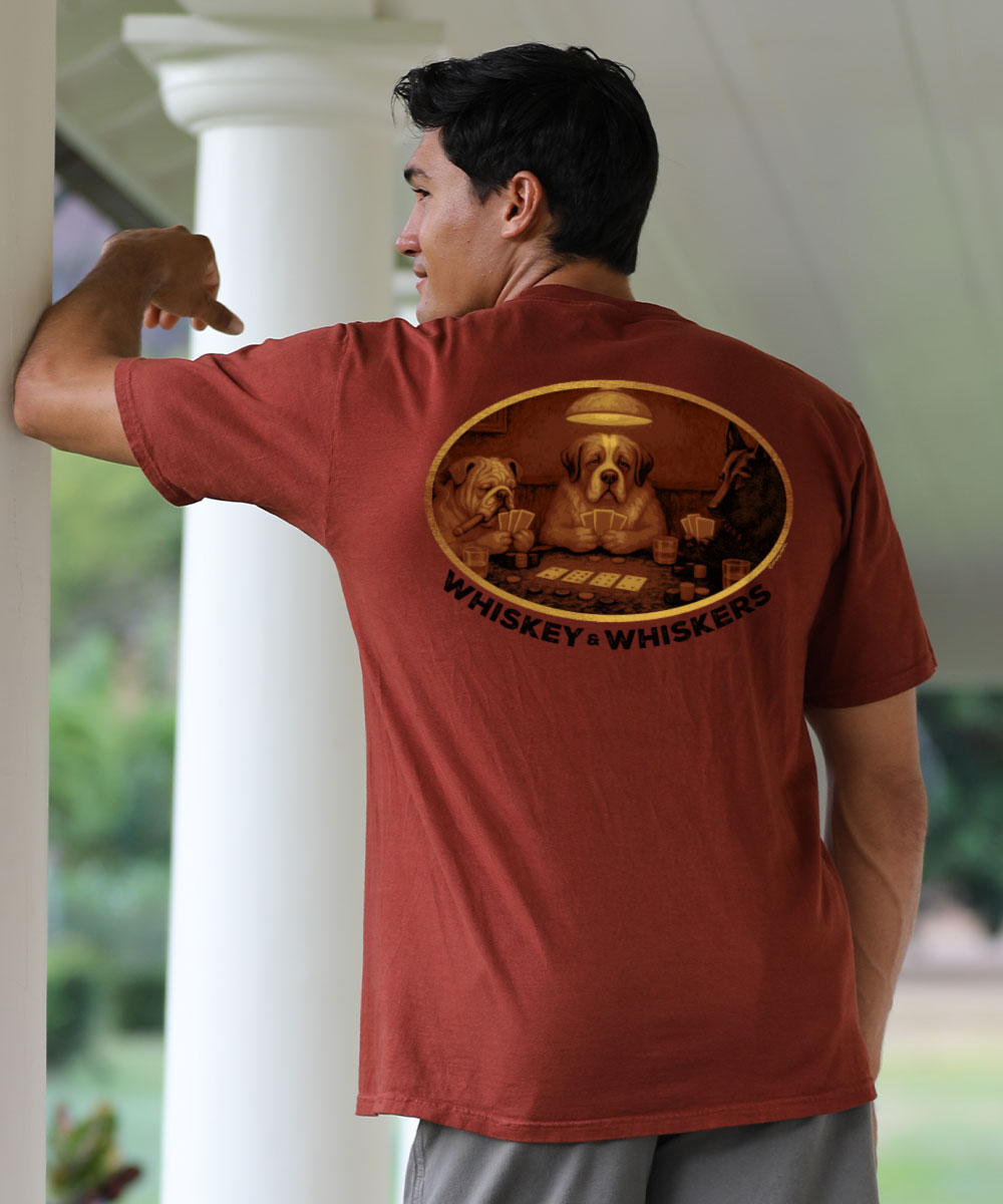 Man wearing a red t-shirt with a graphic design and text, standing outdoors. View 2