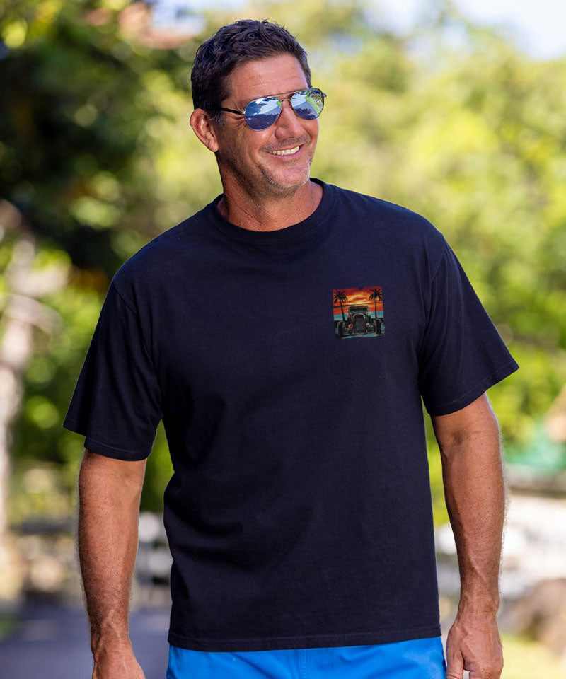 Man wearing a black t-shirt with a colorful graphic on a natural background View 3