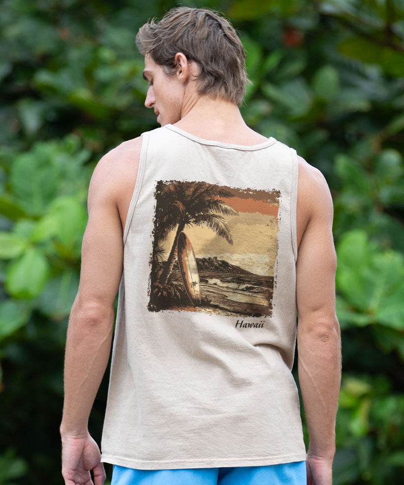 Man wearing a light brown tank top with a graphic on the back, standing outside View 2