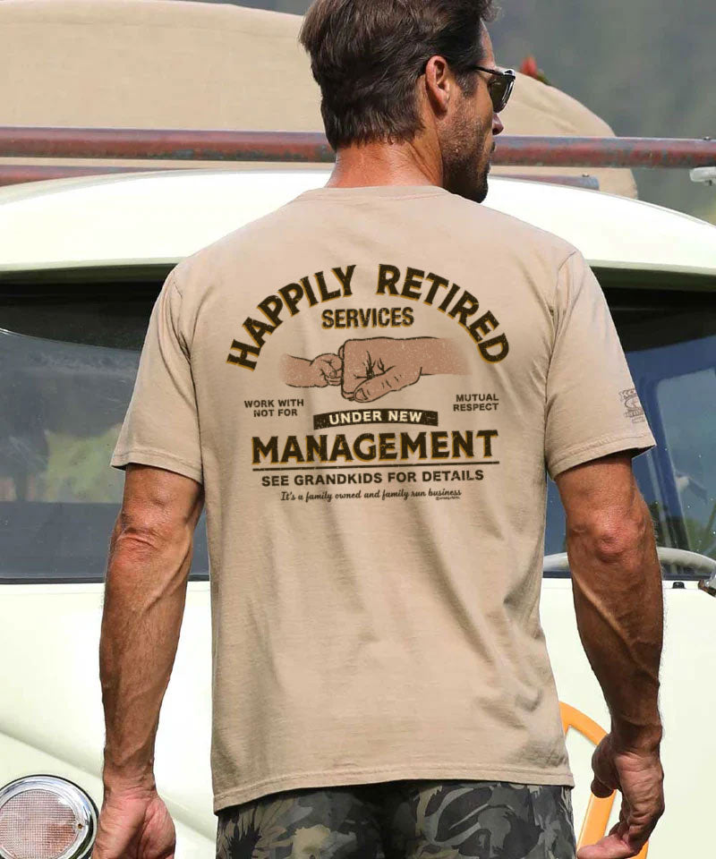 man wearing a humorous beige tee shirt standing in front of a vehicle. View 2