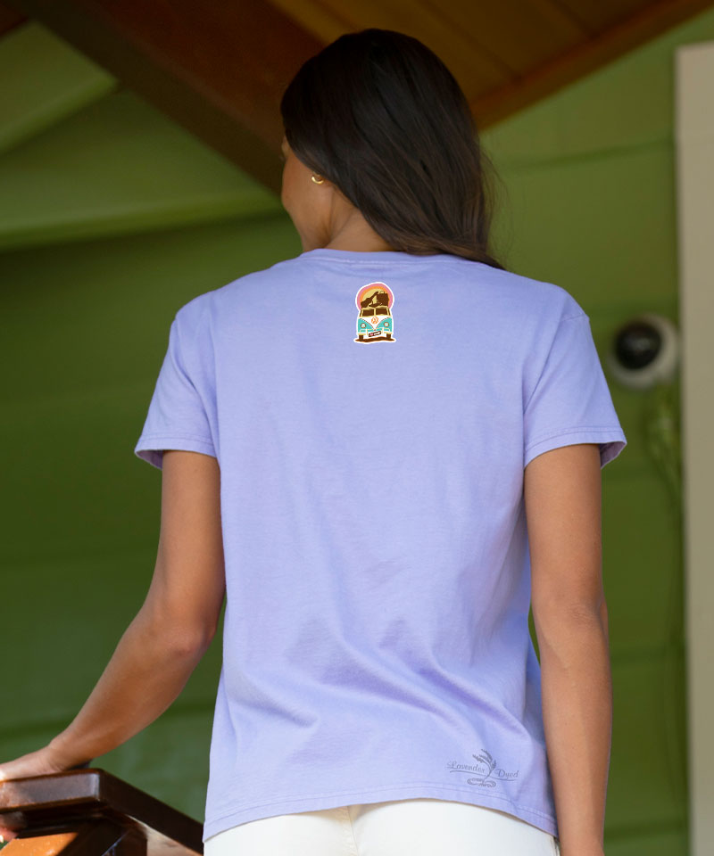 Womanwearing a purple t-shirt with a logo on the back, standing in front of a green wall. View 3