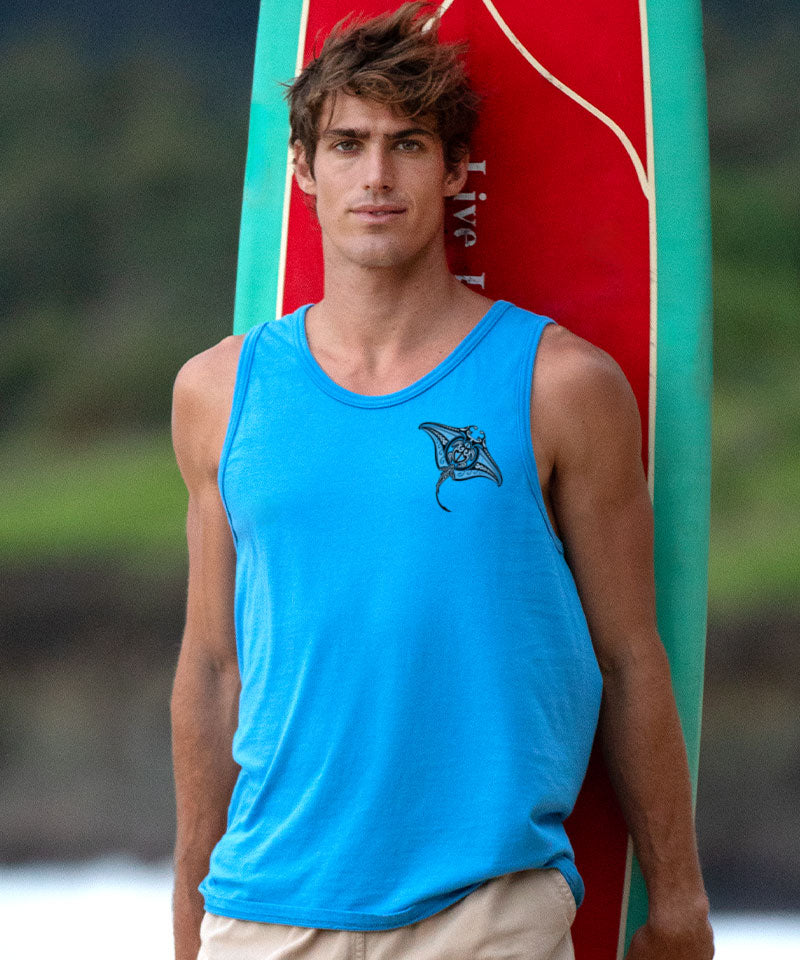 Man wearing a blue tank top with a logo, standing next to a red and green surfboard. View 3