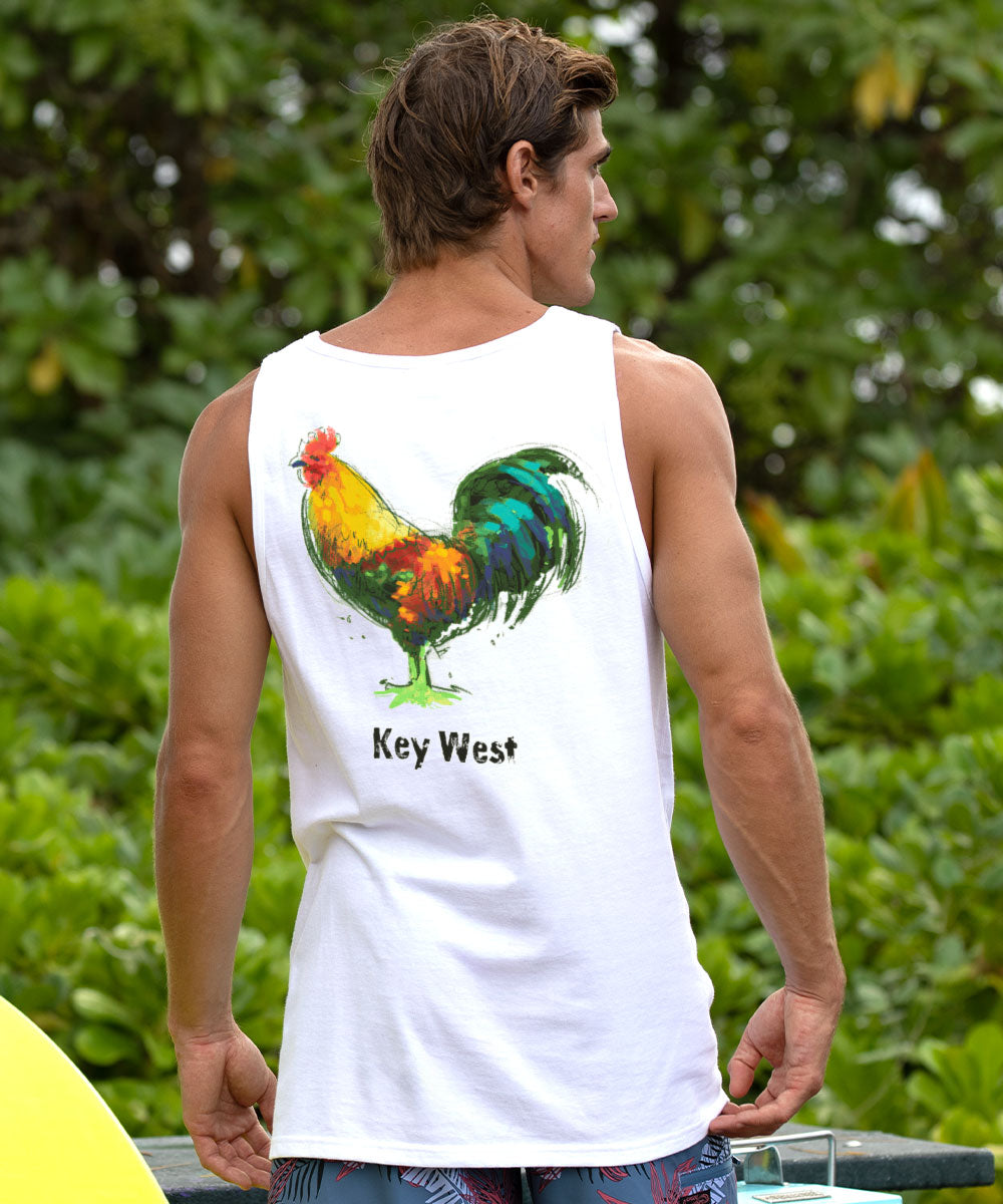 Man wearing a white tank top with a colorful rooster design and 'Key West' text, standing outdoors. View 2