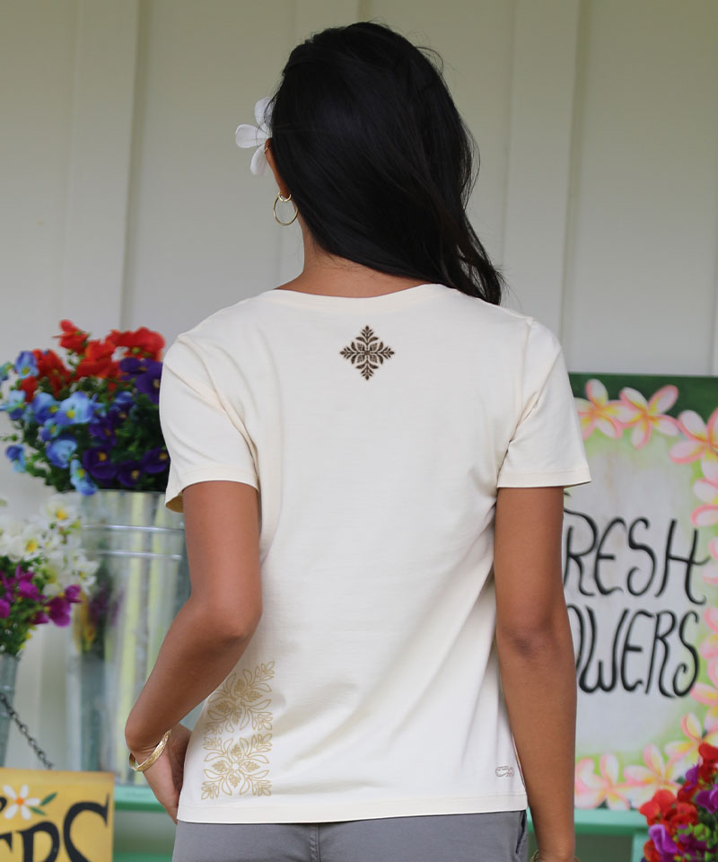 Woman wearing a white blouse with floral embroidery, standing in front of a 'Fresh Flowers' sign. View 3