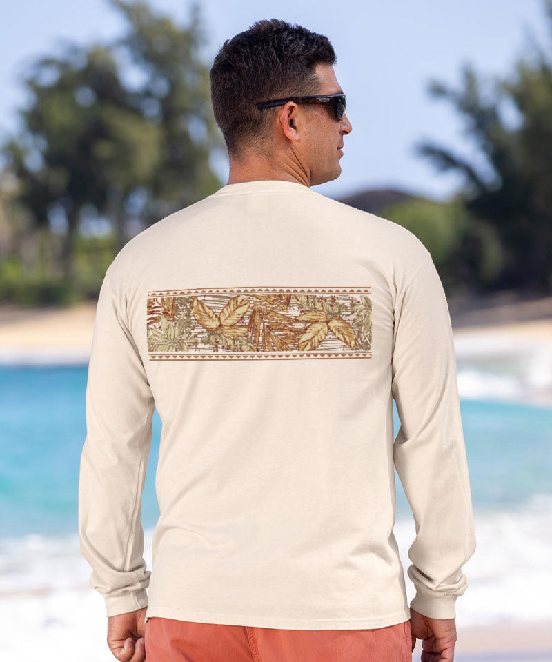 Man wearing a cream long-sleeve shirt with a leaf pattern on the beach View 3