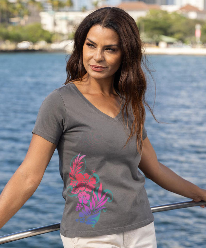 Woman wearing a gray t-shirt with a colorful design by a waterfront View 2