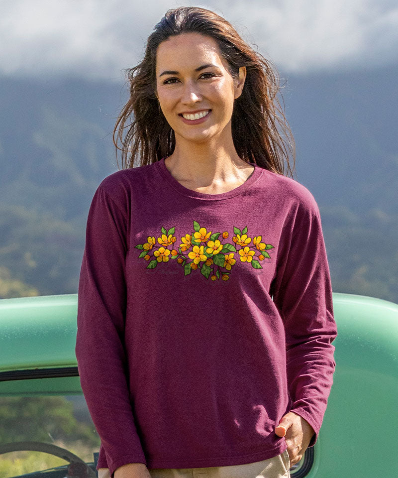 Woman wearing a purple long-sleeve shirt with floral design outdoors View 2