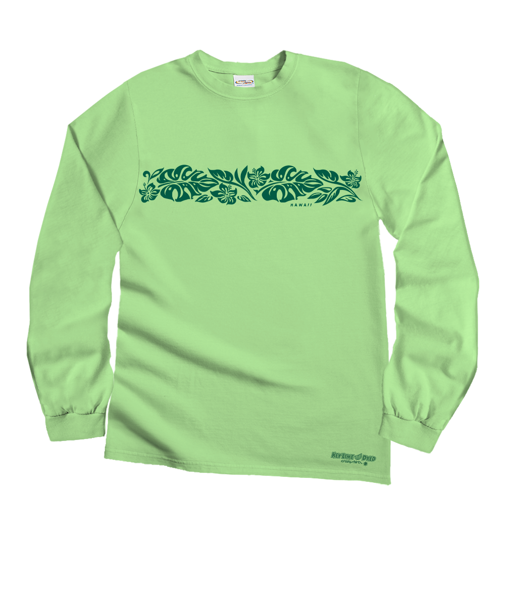 A light green long-sleeve t-shirt with a dark green horizontal tropical leaf pattern across the chest and a small logo near the bottom right hem, displayed flat against a white background. View 1