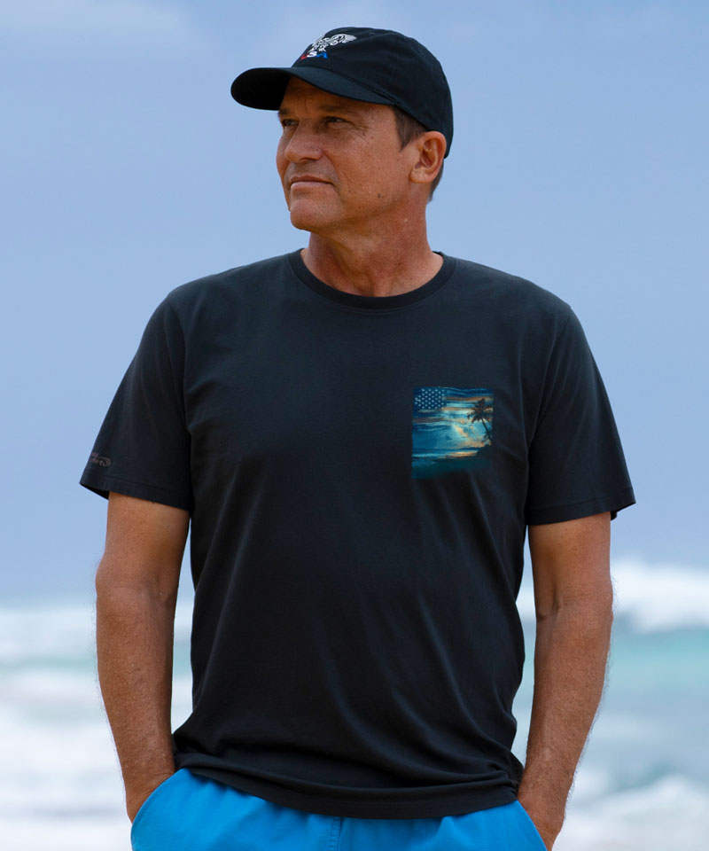 Man wearing a black t-shirt with a pocket design on a beach View 3