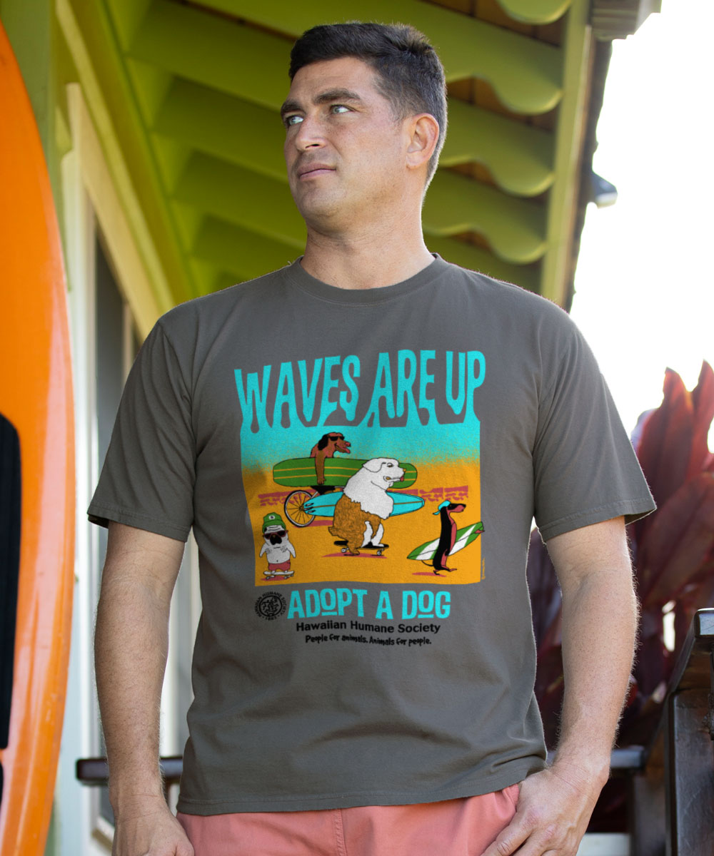 Man wearing a t-shirt with a graphic design and text, standing outdoors. View 2