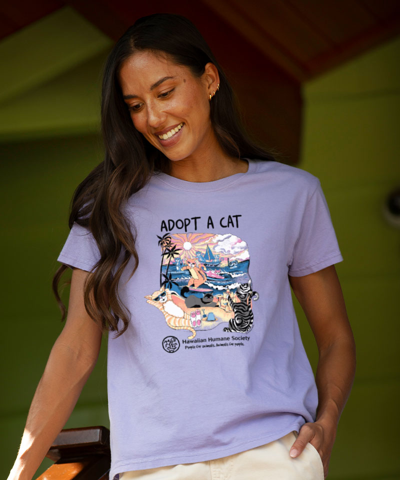 Woman wearing a purple t-shirt with 'Adopt a Cat' graphic design.