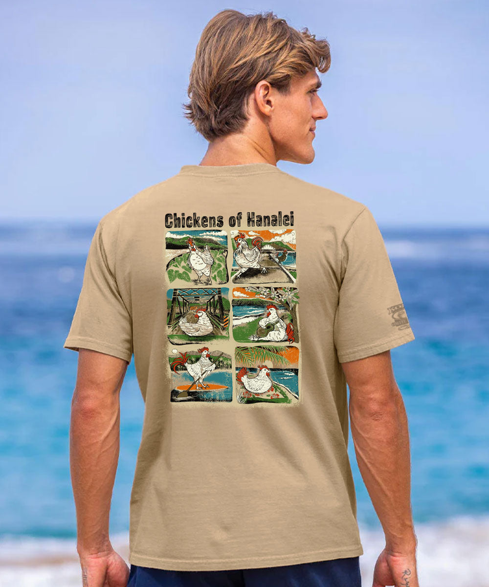 A man wearing a tan graphic t-shirt, viewed from behind, with the ocean and sky blurred in the background. The shirt features a large back graphic titled 'Chickens of Hanalei' containing six vintage-style illustrations of chickens. View 2