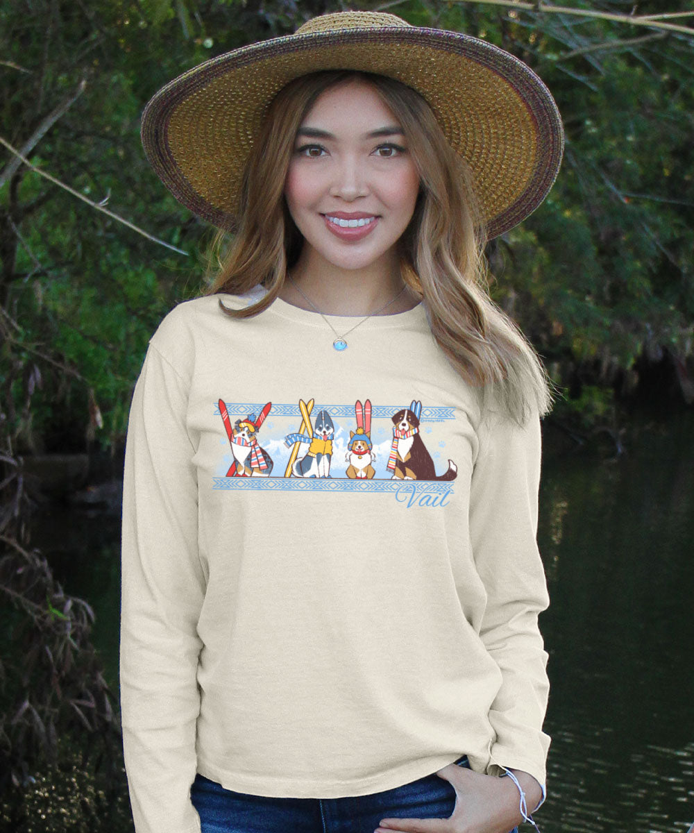 Woman wearing a white long-sleeve shirt with cartoon dog designs outdoors. View 2