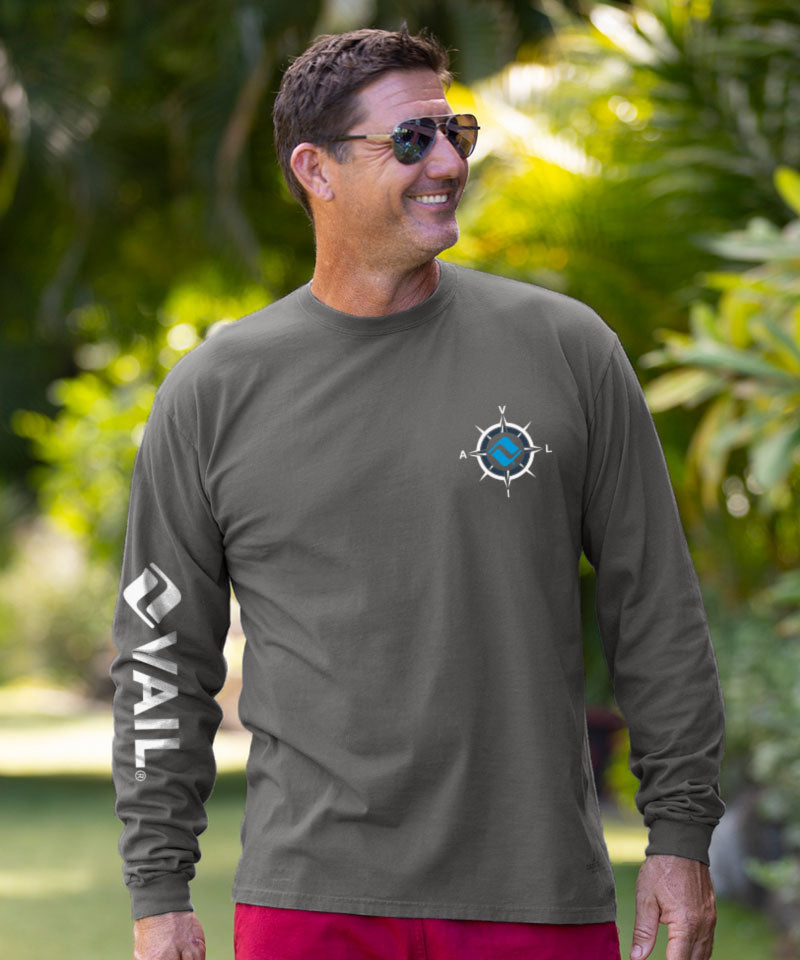 Man wearing a green long-sleeve shirt with a logo and 'Oval' text, standing outdoors. View 3