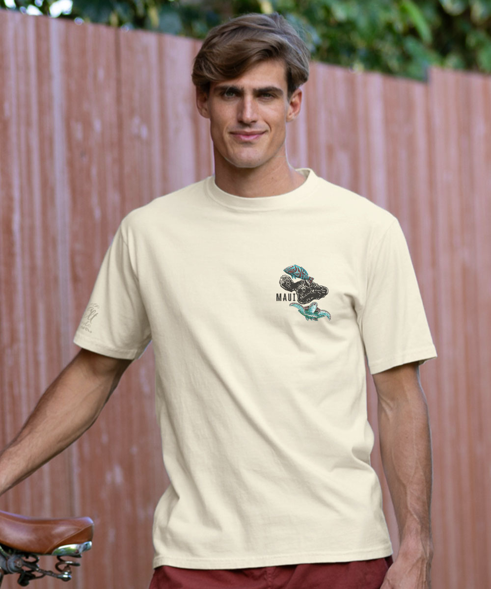 Man wearing a white t-shirt with a graphic design in front of a wooden fence. View 3
