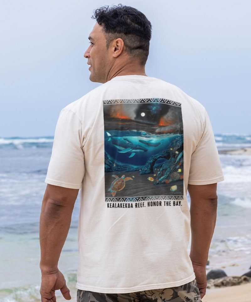 Man wearing a t-shirt with a whale design on the beach