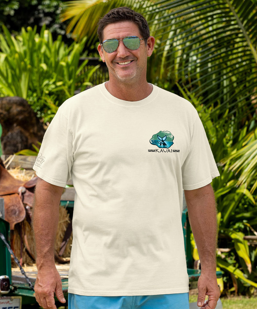 Man wearing a white t-shirt with a logo, standing outdoors with greenery in the background View 3